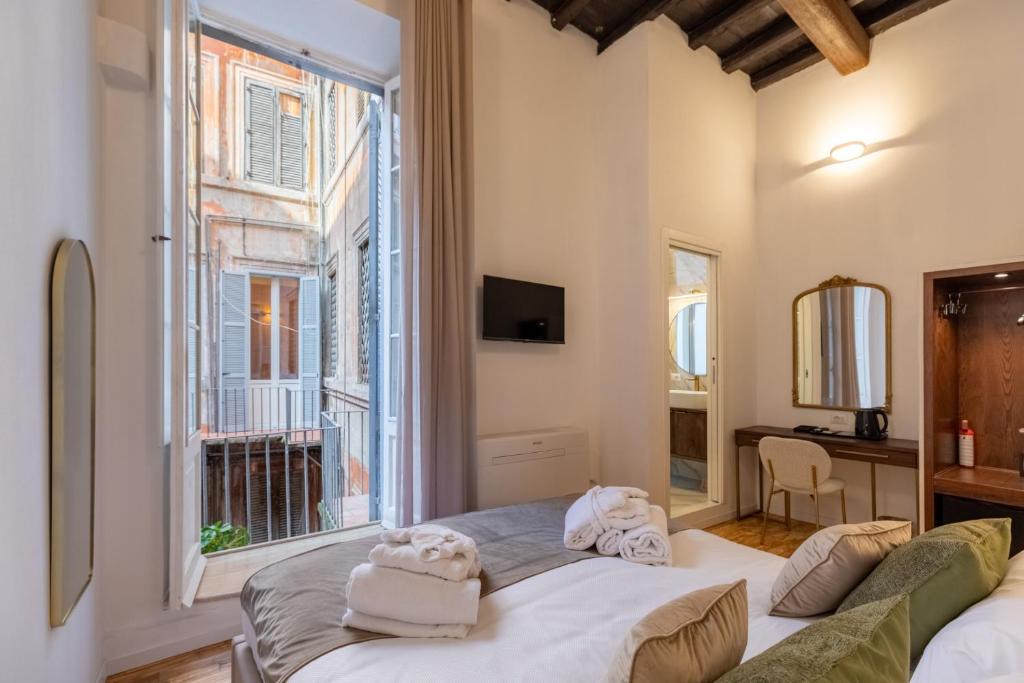 Postel nebo postele na pokoji v ubytování Amelie Suite Trevi