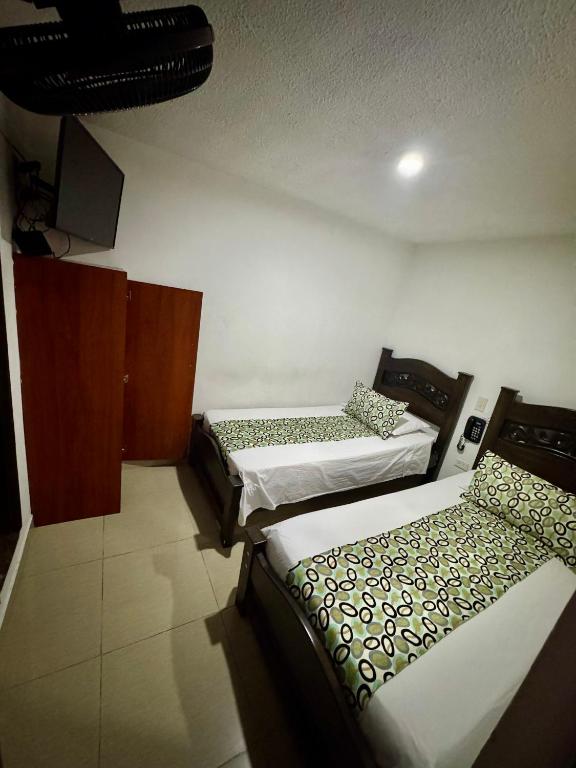 Postel nebo postele na pokoji v ubytování Hotel Tucan Pereira