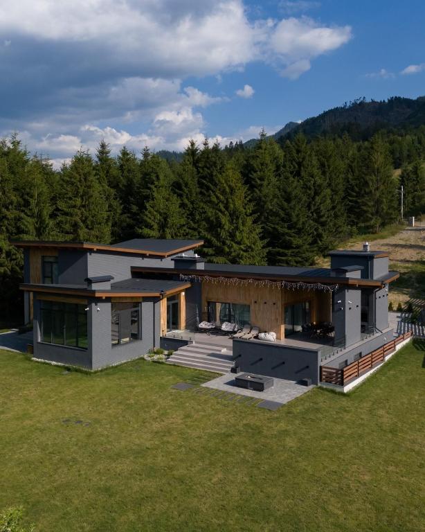 an aerial view of a house with a yard at ArkWood Colibita in Colibiţa