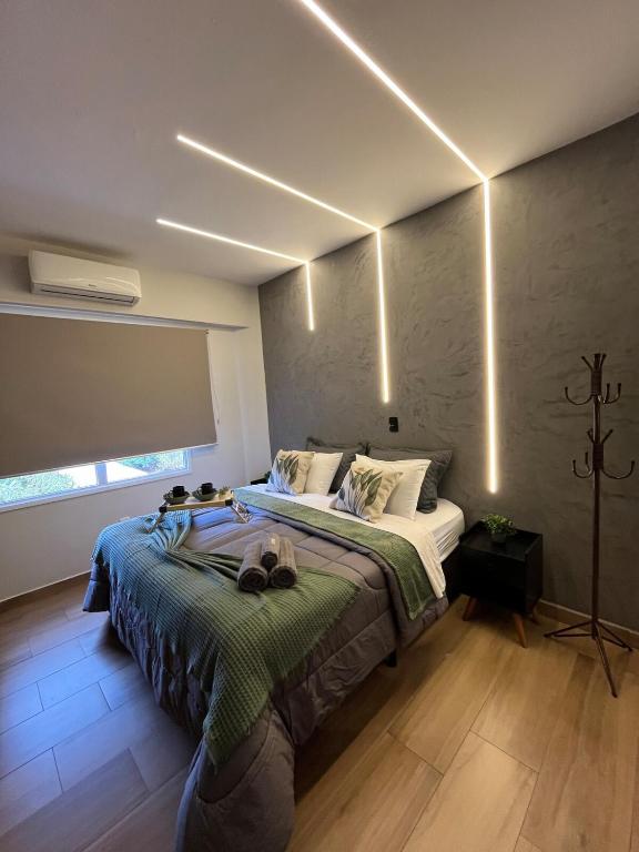a bedroom with a large bed with lights on it at Travellar Spot 12 in Ribeirão Preto
