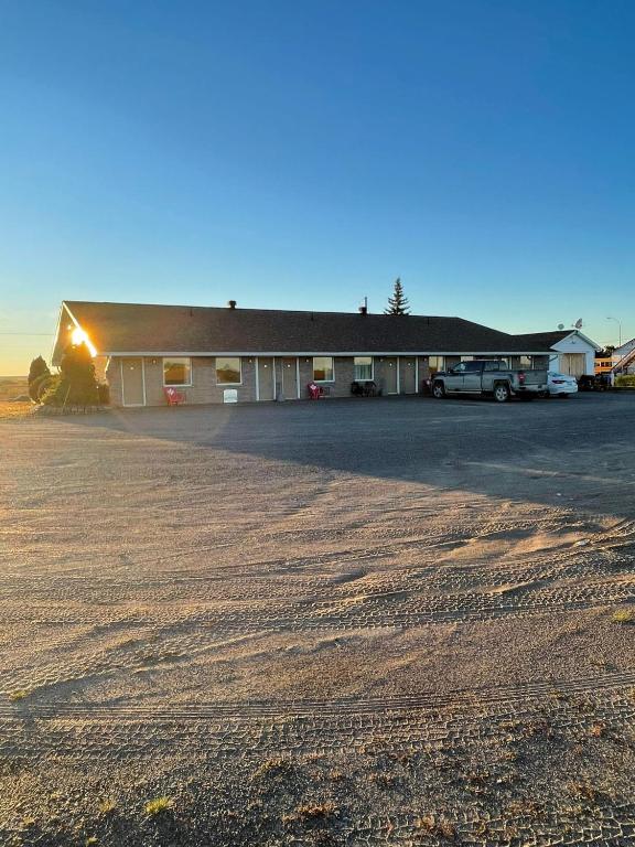 a building with a parking lot in front of it at Earlton Motel in Earlton