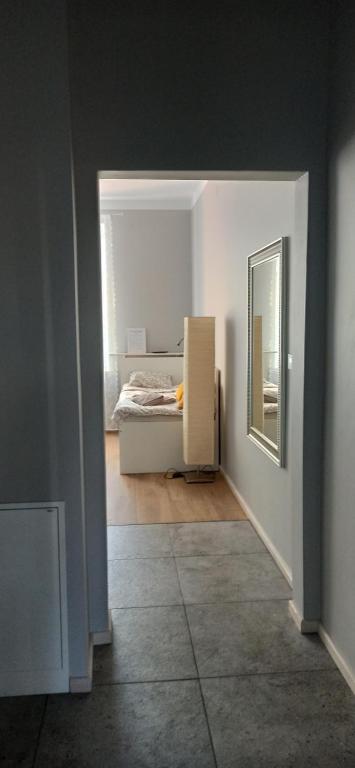 a bedroom with a bed and a mirror in a room at Apartament Rzewuskiego in Przemyśl