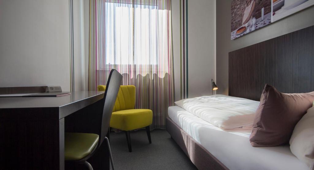Postel nebo postele na pokoji v ubytování GS Hotel