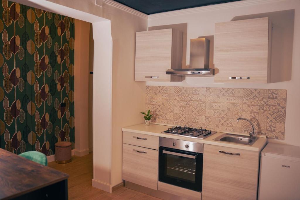 a kitchen with a stove and a sink at La Grande Bellezza in Taranto