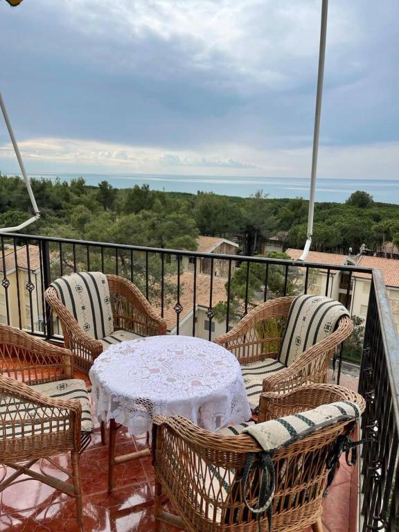 a patio with a table and chairs on a balcony at Vistamar Apartment in Golem