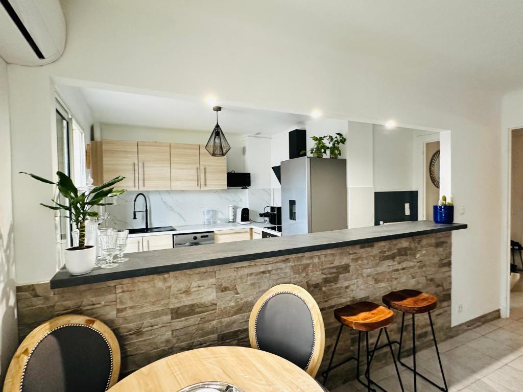 une cuisine avec un comptoir avec des tabourets et une table dans l'établissement Antibes centre-ville, 2 bedrooms 6 pers, Climatisation, à Antibes