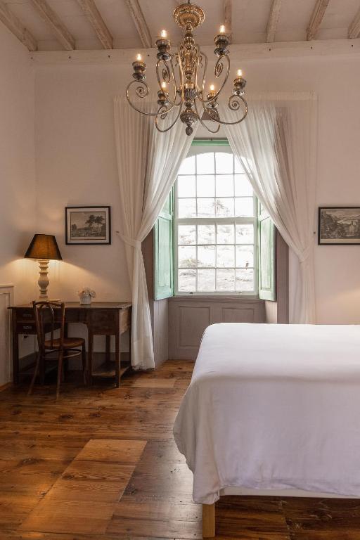 Postel nebo postele na pokoji v ubytování Hotel Emblemático La Casa de los Naranjos