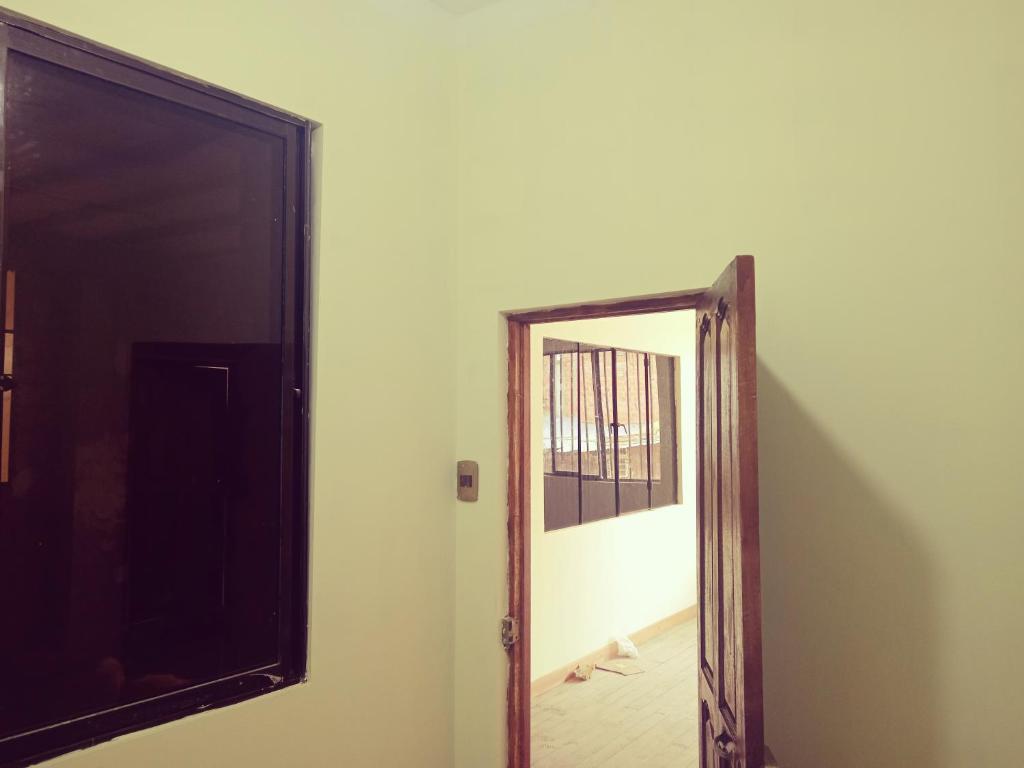 a mirror on a wall next to a door at Aparment equipped and independent in La Paz
