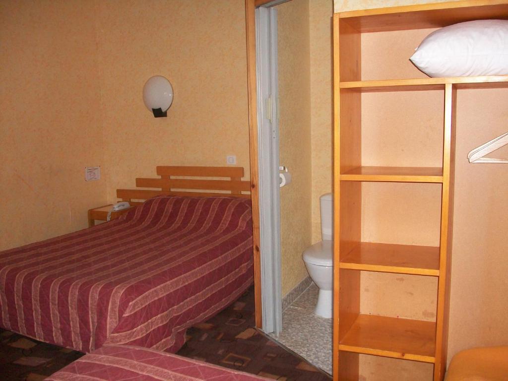 Postel nebo postele na pokoji v ubytování Hotel L'Aiglon
