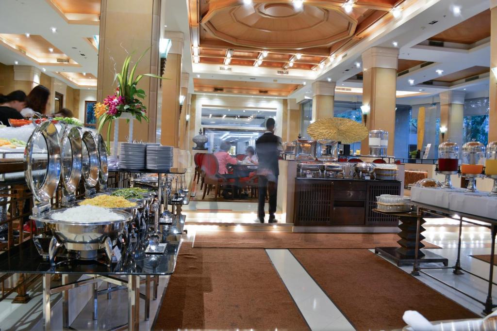 A busy buffet room with multiple serving stations.