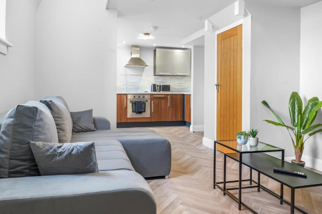 a living room with a couch and a table at St George's Quarter - Luxury Stays - Duplex - FREE PARKING - Home From Home - FREE WIFI - Newly Renovated - Moorfeilds in Liverpool