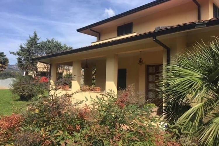 a yellow house with plants in front of it at Holiday Home Camaiore near Lido Beaches in Camaiore