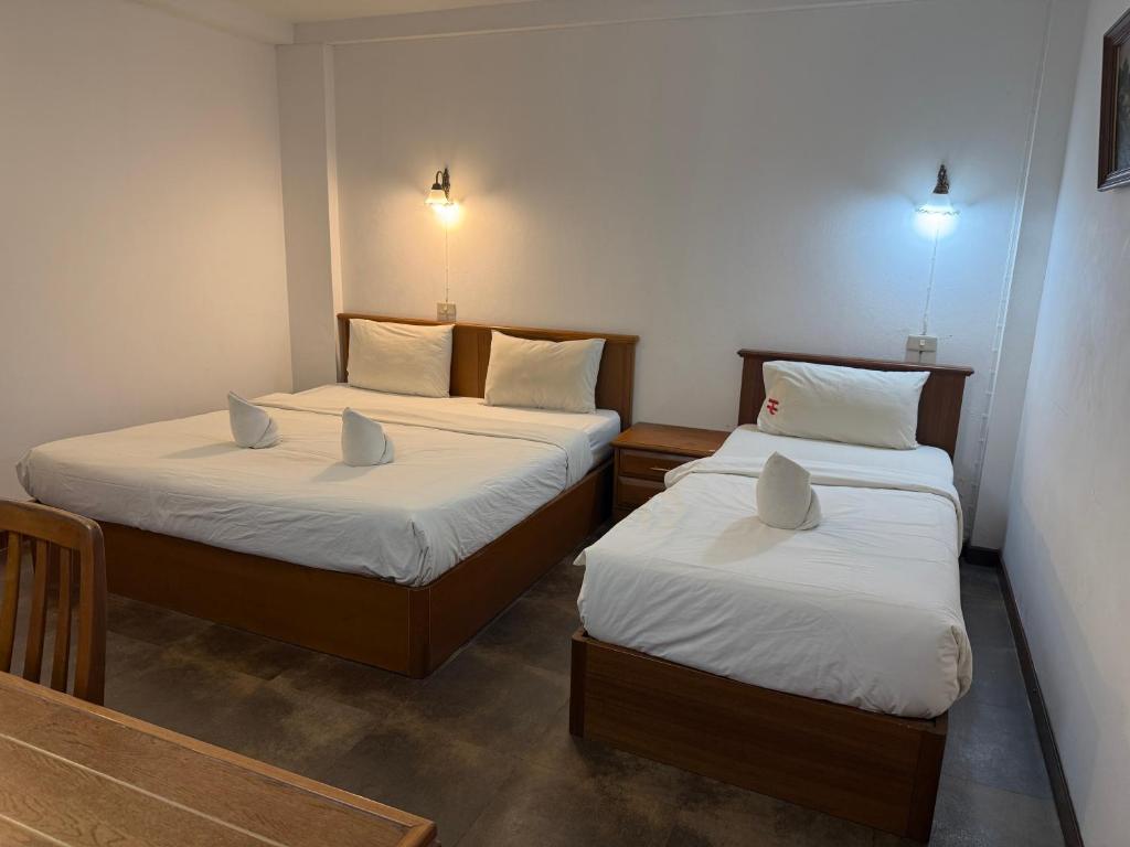 Postel nebo postele na pokoji v ubytování Hua Lin Inn