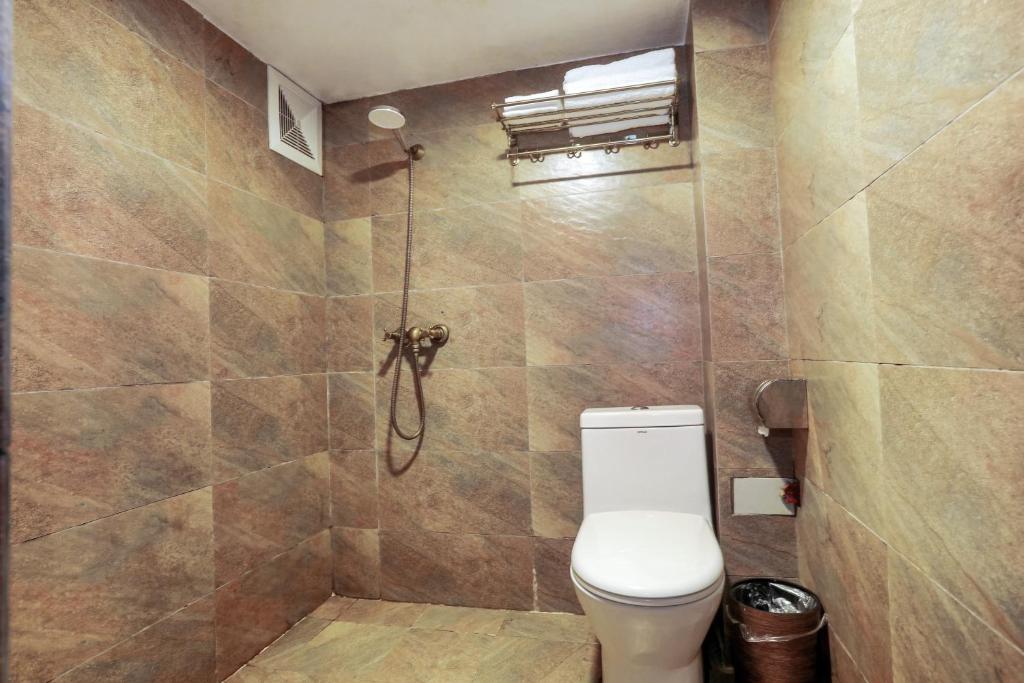a bathroom with a toilet and a shower at 张家界畔山驿栈 in Zhangjiajie