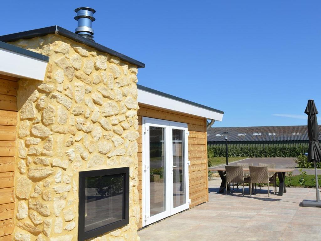 a stone facade of a house with a patio at Holiday Home in Bemelen near Nature Reserve in Bemelen