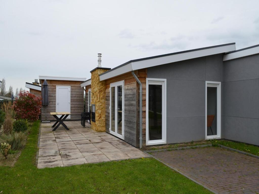 a small house with a patio in the yard at Holiday Home Bemelen near Nature Reserve in Bemelen