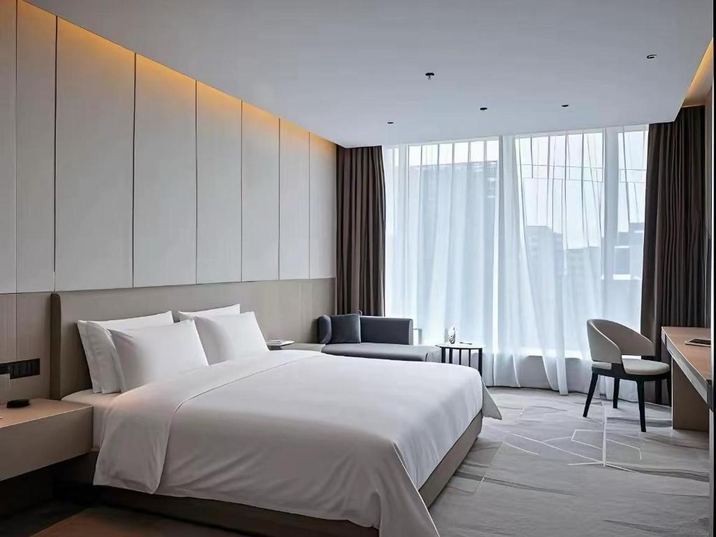 Postel nebo postele na pokoji v ubytování Paco Hotel Guangzhou Baiyun Airport Liantang Metro