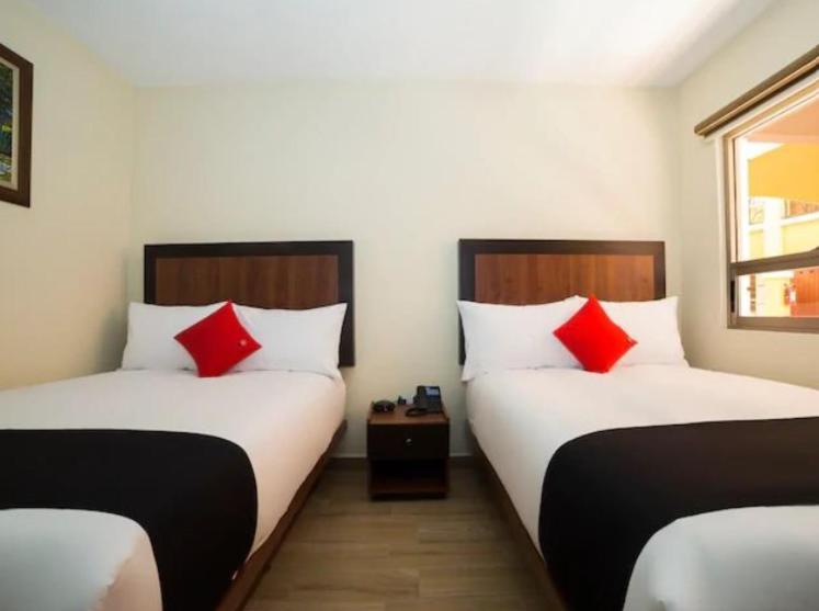 Postel nebo postele na pokoji v ubytování Hotel Colonial Acopinalco Inn