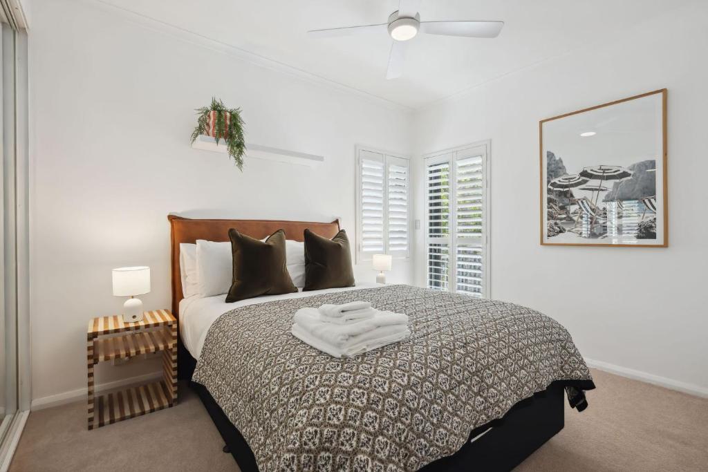 a bedroom with a large bed with a wooden headboard at NAIR6C - Central Freo Luxe Stay in Fremantle