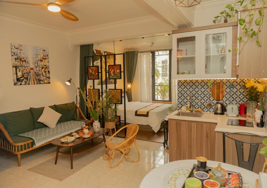 a living room and kitchen with a couch and a table at Amazing View, Natural View, 3' To Hoan Kiem Lake, Free Wifi, Netflix, 2 Beds, 1 Toilet-2 Showers in Hanoi