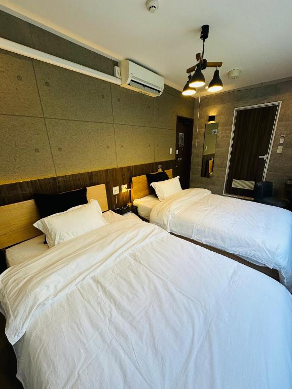 Postel nebo postele na pokoji v ubytování e-hostel 心斎橋 双床房