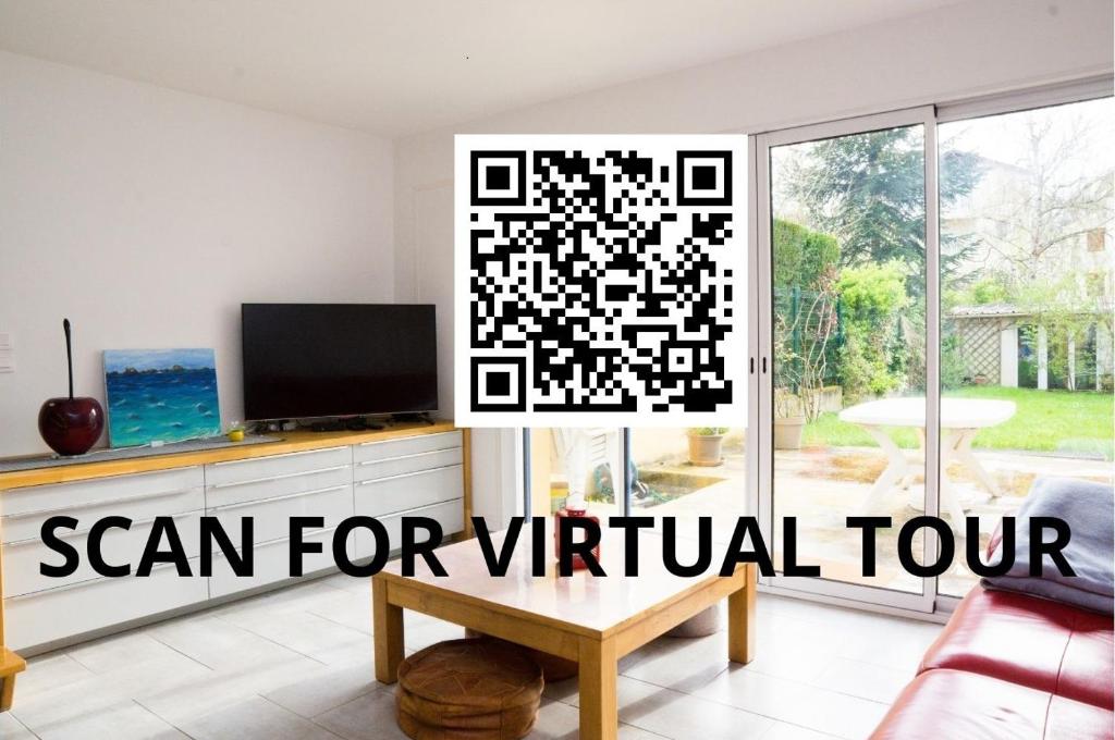 a modern living room with a qr code sign on a window at EXIGEHOME - Maison à 2 pas de la foret - 10 min de Versailles in Vélizy-Villacoublay