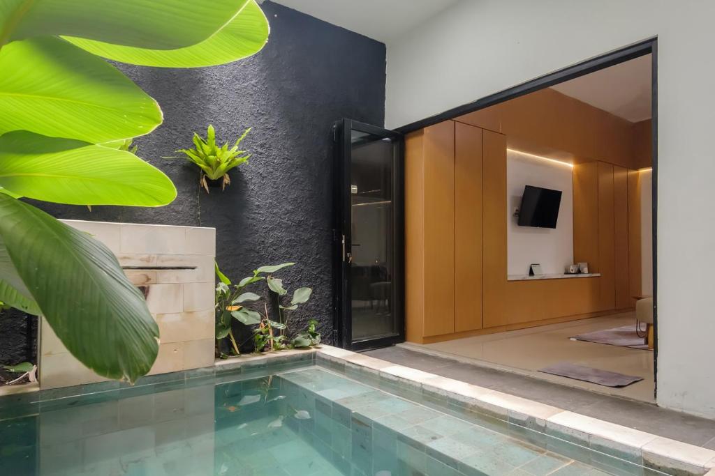 a house with a swimming pool and a bathroom at INNCA The Amerta Private Villa, Solo in Solo