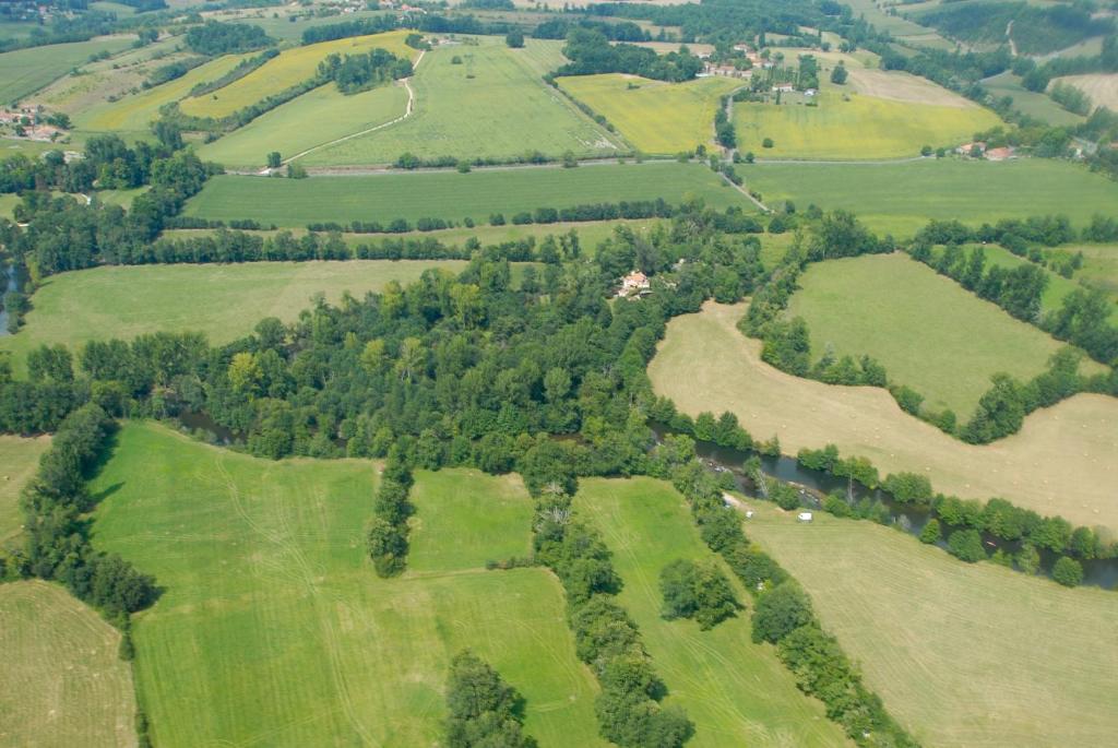 an aerial view of green fields and trees at Moulin De Larcy in Ribérac