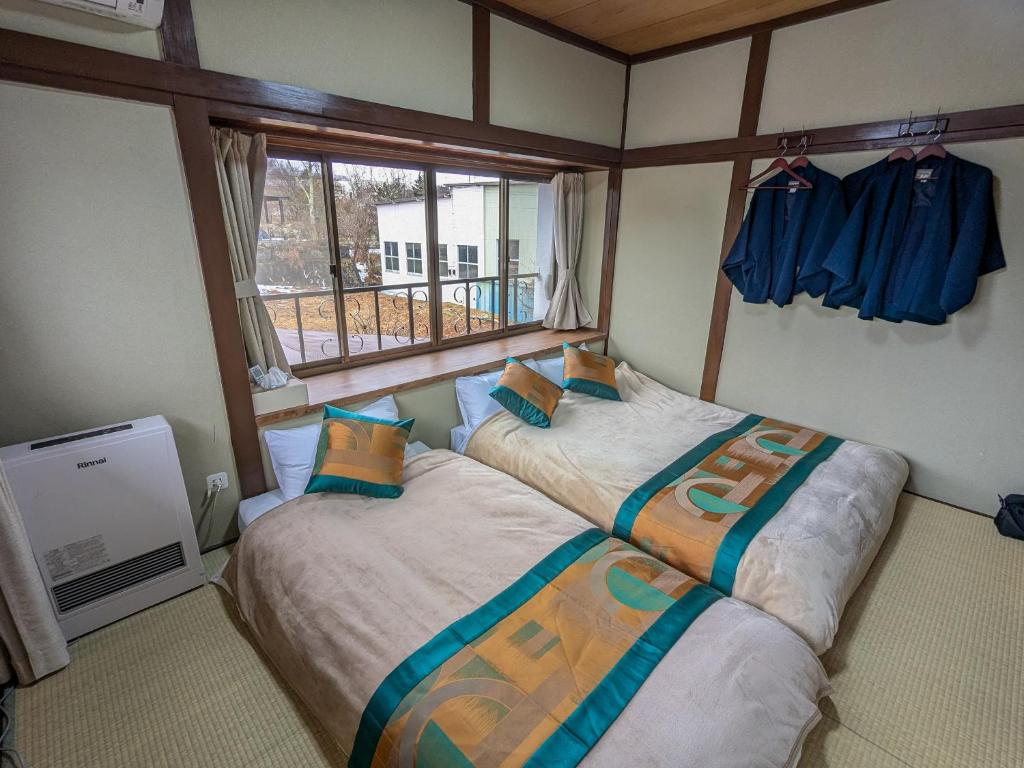 Postel nebo postele na pokoji v ubytování 富士たから荘山中館
