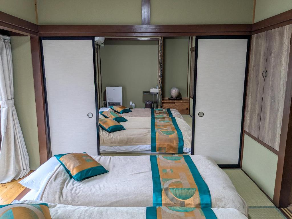 Postel nebo postele na pokoji v ubytování 富士たから荘山中館