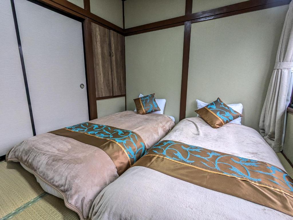 Postel nebo postele na pokoji v ubytování 富士たから荘山中館