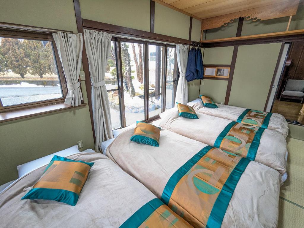 Postel nebo postele na pokoji v ubytování 富士たから荘山中館