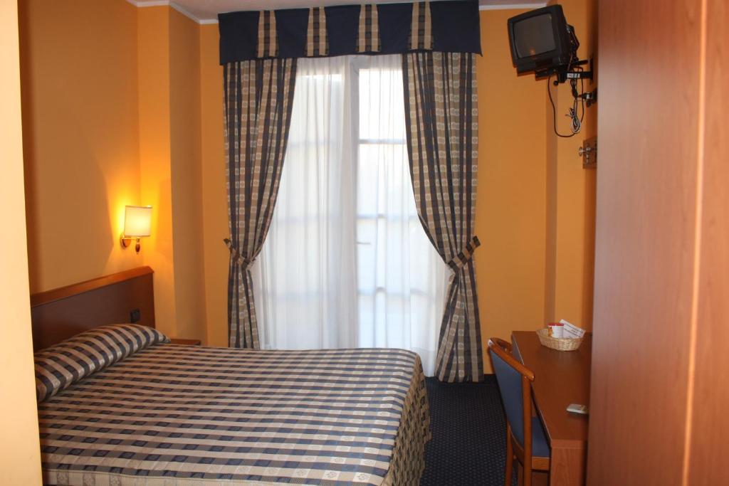 Postel nebo postele na pokoji v ubytování Hotel Tre Denti