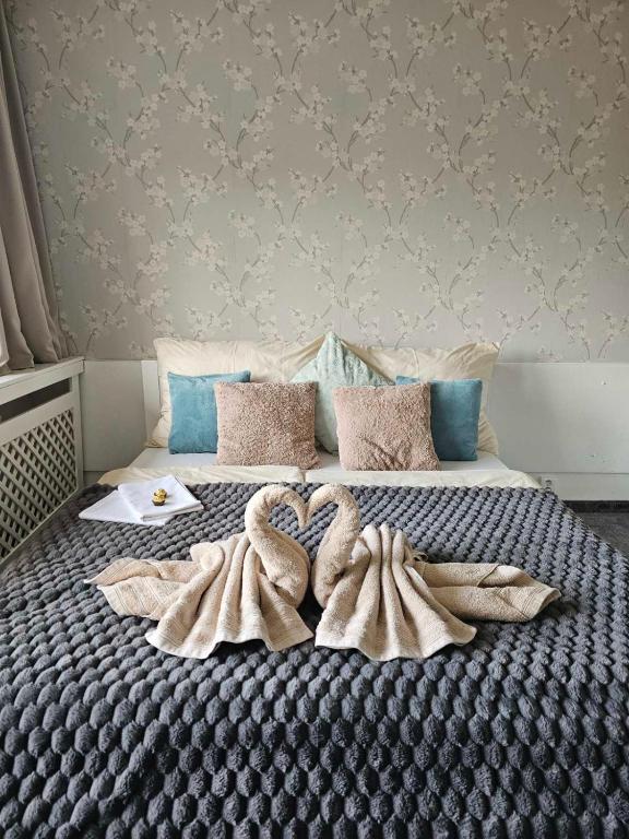 a large bed with two towels on it at Apartmán Filip wellness,krytý bazén in Tatranska Strba