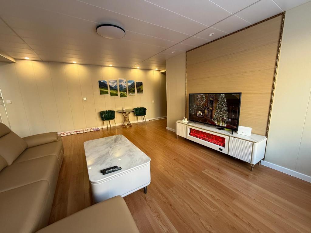 a living room with a couch and a flat screen tv at Comfy classic apartment in Central UB in Ulaanbaatar