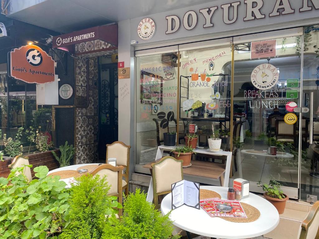 a restaurant with a table and chairs in front of a store at Goji's Apartments in Istanbul