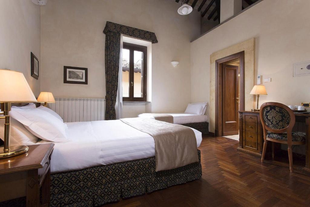 Postel nebo postele na pokoji v ubytování Hotel Teatro Pace