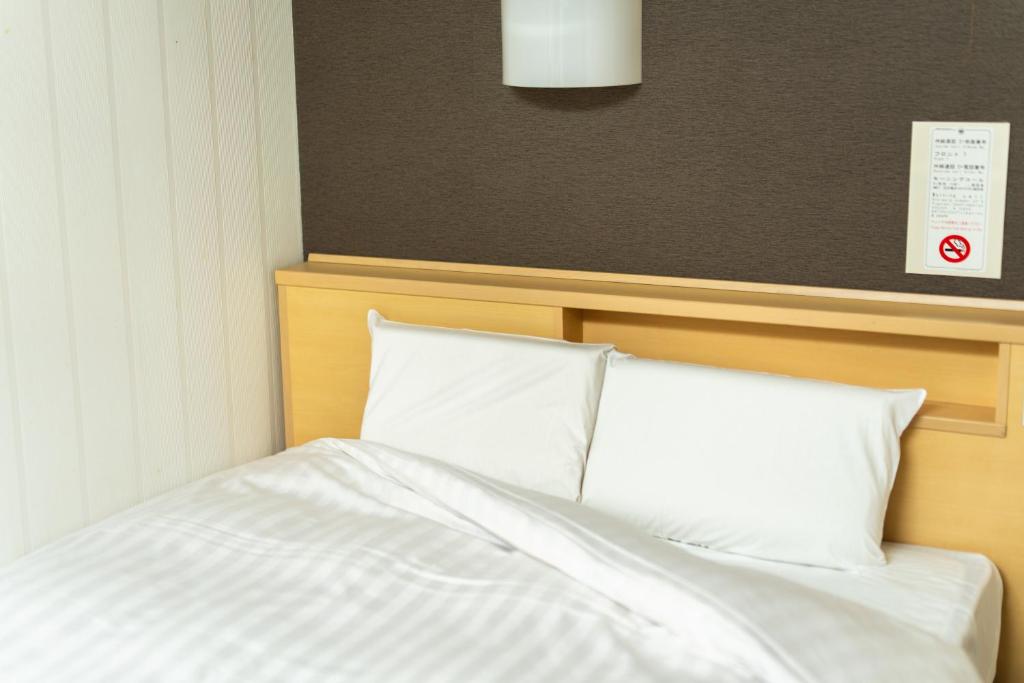 Postel nebo postele na pokoji v ubytování Ramada Encore by Wyndham Amagasaki