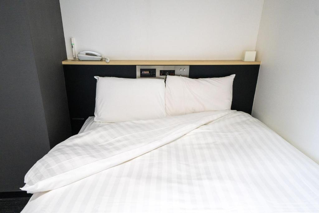 Postel nebo postele na pokoji v ubytování Ramada Encore by Wyndham Amagasaki