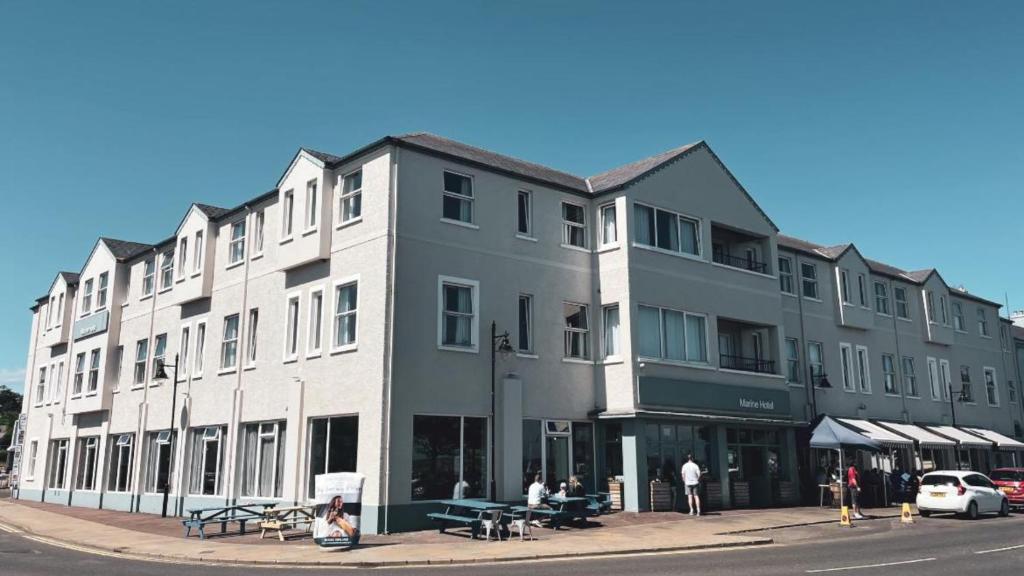 a large building on the corner of a street at Marine Hotel Ballycastle in Ballycastle