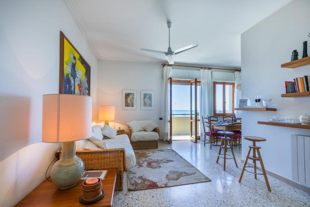 a living room with a couch and a table at Italianway - Rossetti 3 in Marina di Cecina