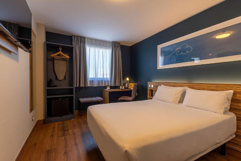 a hotel room with a bed and a desk at Travelodge Barcelona Poblenou in Barcelona