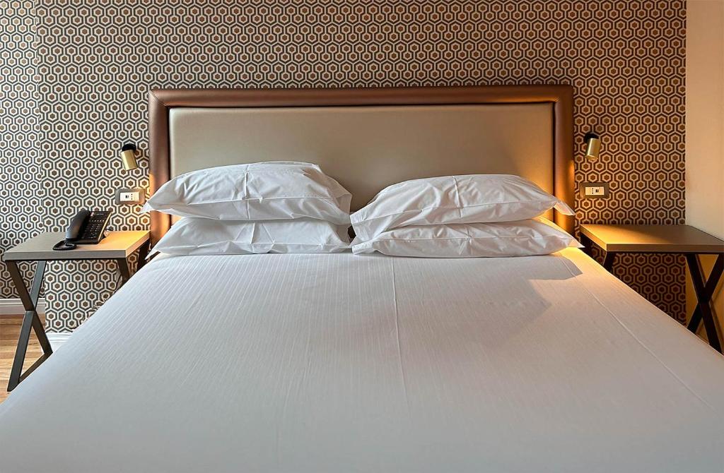 Łóżko lub łóżka w pokoju w obiekcie Caruso Place Boutique & Wellness Suites