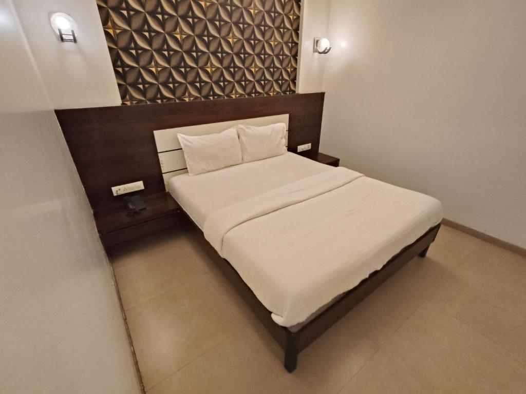Säng eller sängar i ett rum på Hotel Vijay Sagar Dombivali