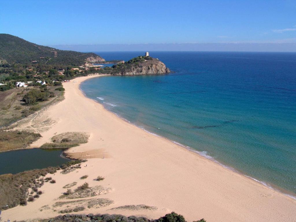 an aerial view of a beach with a lighthouse at Hotel Spartivento in Chia