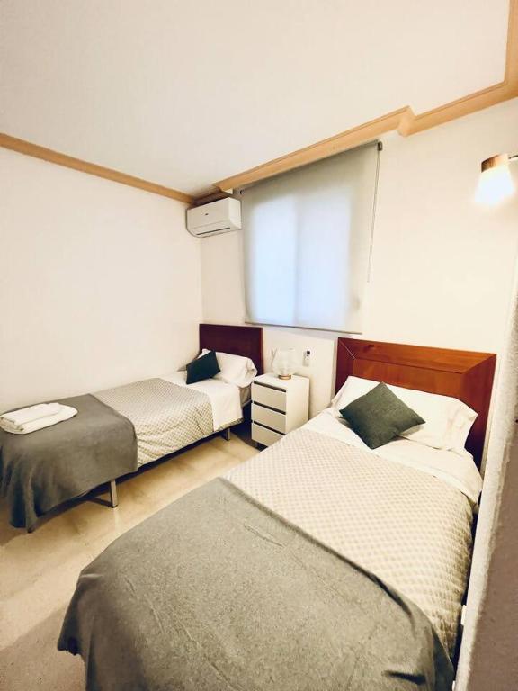 Łóżko lub łóżka w pokoju w obiekcie Relaxdiversión en Villa Piscina bbq y cocina ext