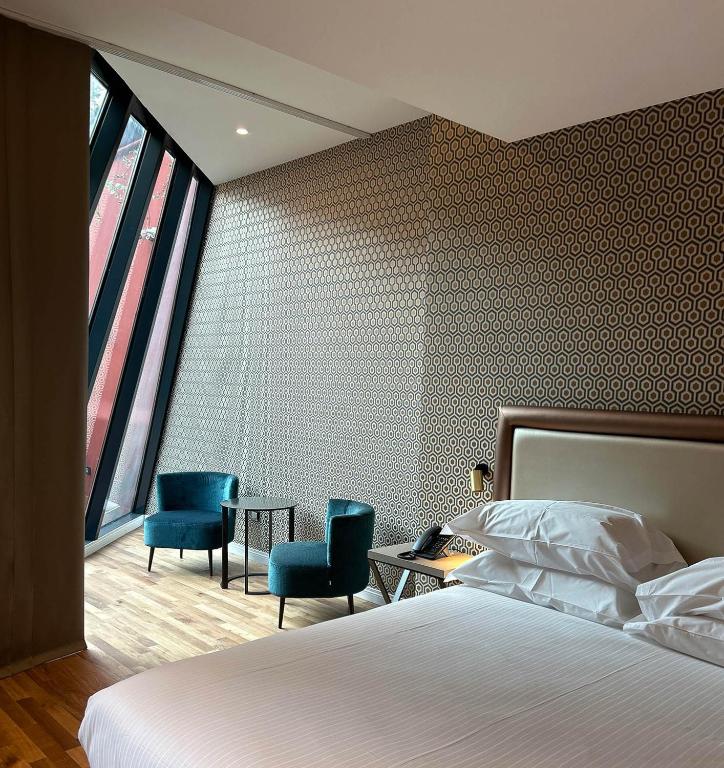 Łóżko lub łóżka w pokoju w obiekcie Caruso Place Boutique & Wellness Suites