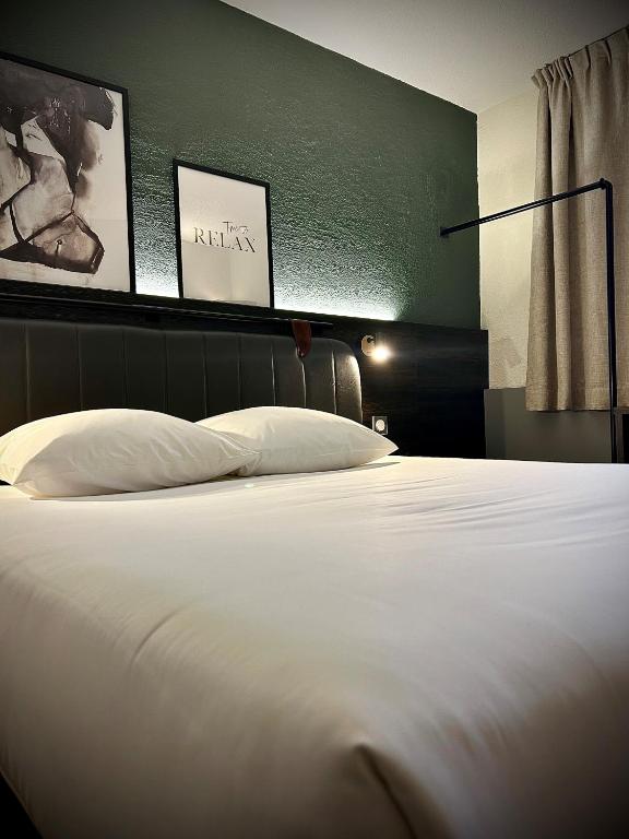 Postel nebo postele na pokoji v ubytování Tulip Inn Beaune
