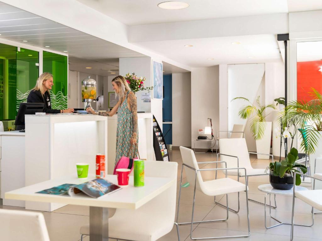 two women standing at a counter in a store at Ibis Styles Menton Centre in Menton