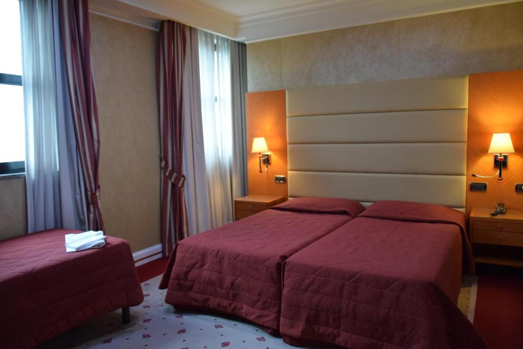 Postel nebo postele na pokoji v ubytování Hotel Perusia